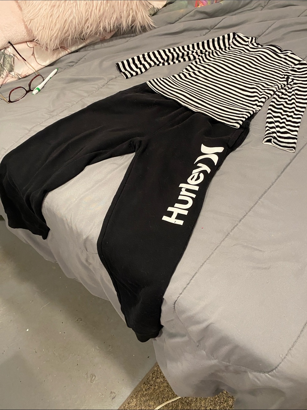 This is a sat/2 i Hurley Black Sweatpants and a white & black stripes shirt